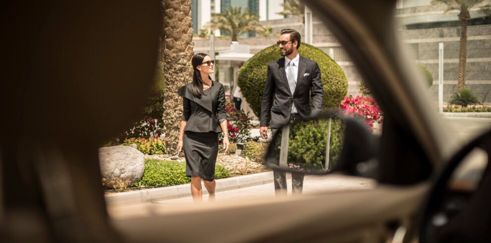 Travelers walking to their private driver in Morocco outside a hotel